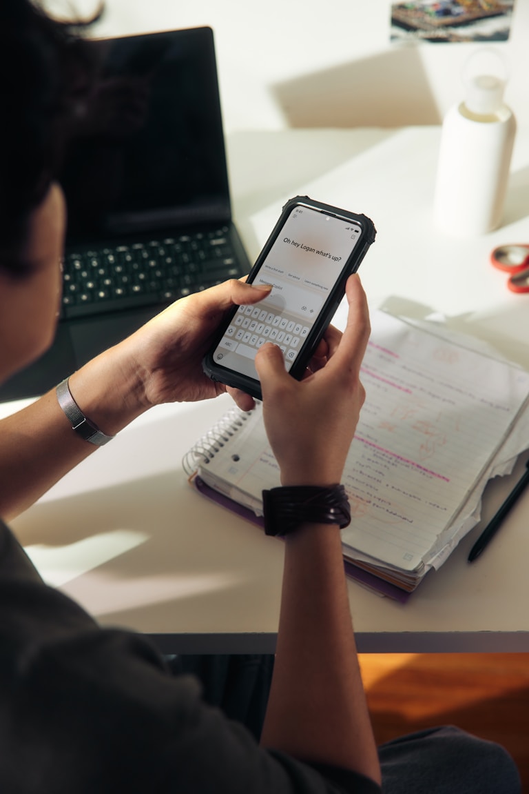 Testing a Kervon utility app on a phone alongside written notes
