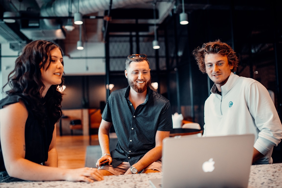 Three Kervon colleagues talking through a project over a laptop